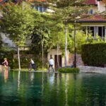 people riding bikes near a body of water